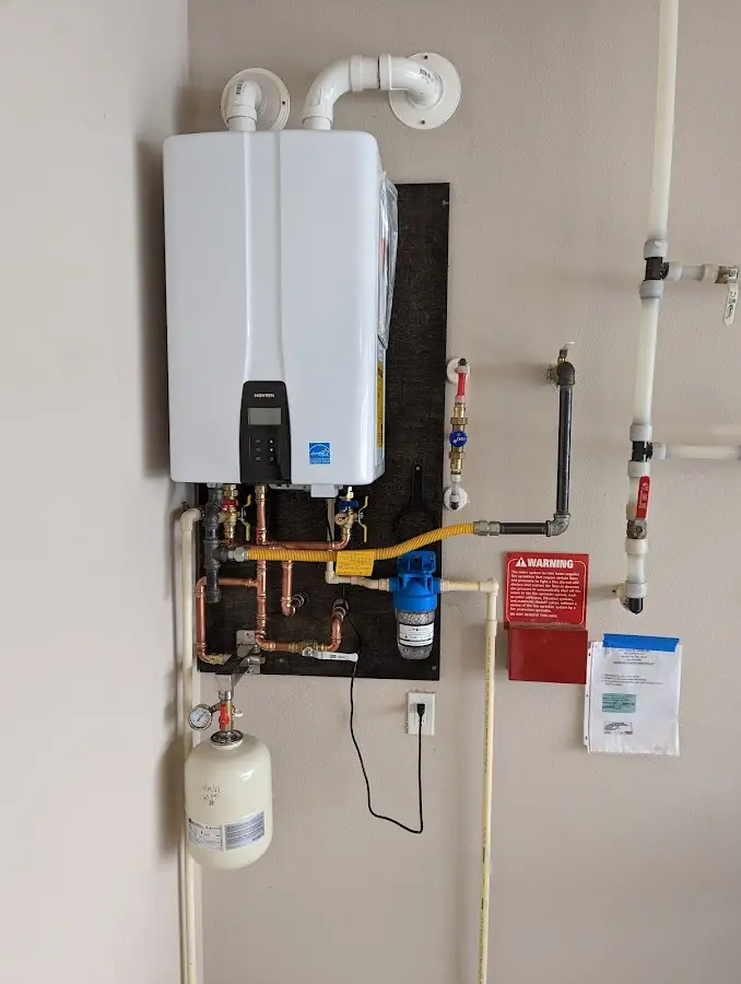 Professional plumber installing copper piping in a Wenham home